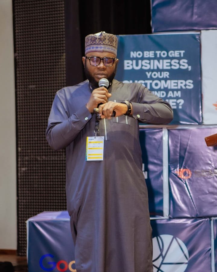 Shehu AbdulGaniy speaking on stage at Search Africon